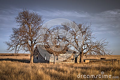 Old abandoned farmhouse on the prairie of Colorado at sunset Stock Photo