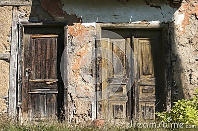 Old abandoned grunge rural house doors Stock Photo