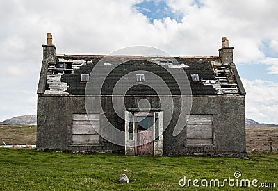 Old abandoned house in the countryside with broken roof Stock Photo