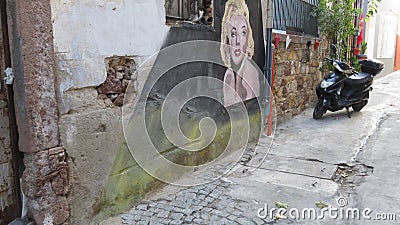 An old abandoned house. Stone wall and street art painting Marilyn Monroe. Editorial Stock Photo