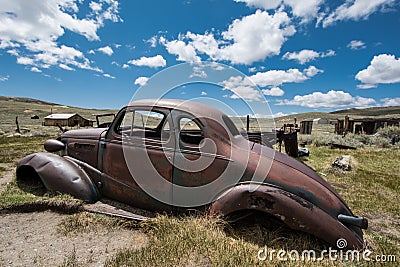 Old abandoned jalopy car sitting in Bodie State Historical Park, a gold rush ghost town Stock Photo