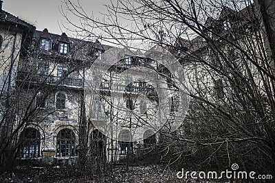 Old abandoned mansion in mystic spooky forest. Haunted house with dark atmosphere, full moon, bats and creepy details like in horr Stock Photo