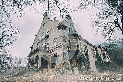 Old abandoned mansion in mystic spooky forest Stock Photo