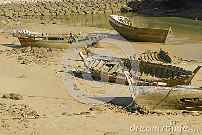 Old and abandoned rowing boat stranded on the shore of the in Cadiz Stock Photo