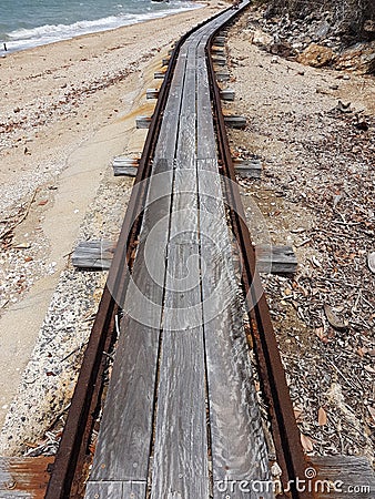 Old abandoned rusty rail track on island on Australian north coast Queensland Stock Photo
