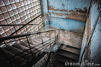 Abandoned staircase angle shot in damaged corridor Stock Photo