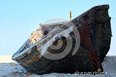 Old abandoned wooden fishing boat with rusted nails by the sea Stock Photo