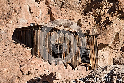 Old abandoned wooden house in mountain desert rock. Stock Photo