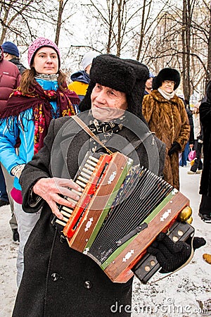 An old accordion players dressed in a Russian Ushanka Editorial Stock Photo