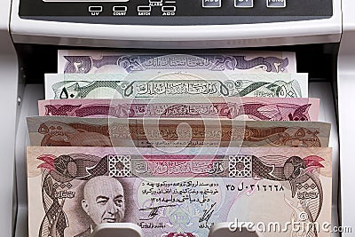 Old Afghan Afghani in a counting machine Stock Photo