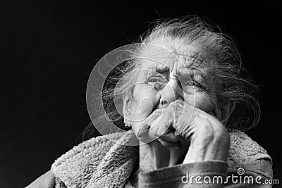 Very old and tired wrinkled woman outdoors Stock Photo