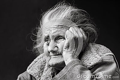 Very old and tired wrinkled woman outdoors Stock Photo