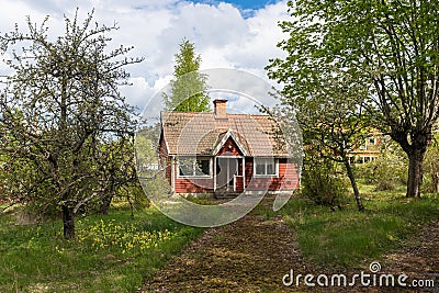 Old aged abandoned cabin house in the woods. Dacha or guest house. Nobody lives there. The old wooden building fell into disrepair Stock Photo