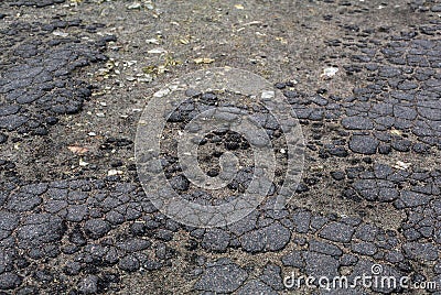 Old aged grey cracked asphalt road surface Stock Photo