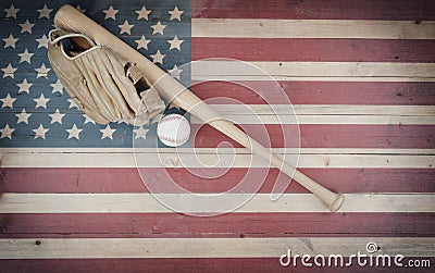 Old American baseball equipment on vintage United States wooden flag setting Stock Photo