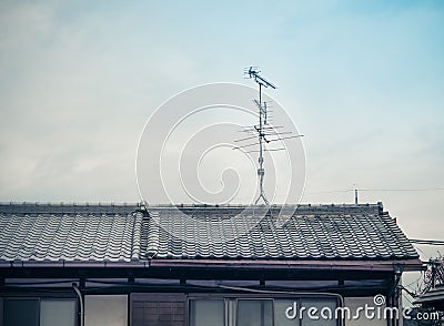 Old analog antenna for TV with blue sky background. Stock Photo