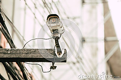 Old analog CCTV outdoor device on wood pole Stock Photo