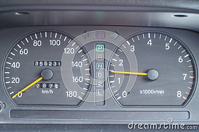 An old analog dashboard of a Japanese car. Speedometer up to 180 km and tachometer up to 8000 rpm Stock Photo