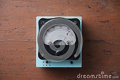 Old analog voltmeter with a metal arrow. Stock Photo