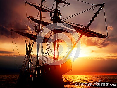 Old ancient pirate ship on peaceful ocean at sunset. Stock Photo