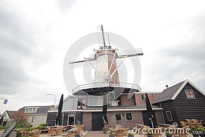 Old ancient windmill along river Old Rhine in city of Bodegraven whch became beer brewery. Stock Photo