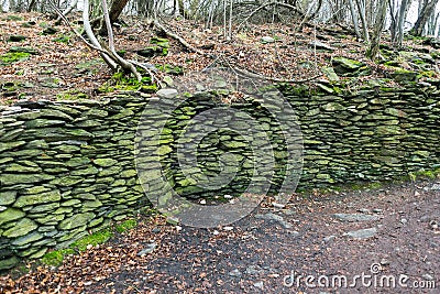 Old antique forest fortification wall stacked stones Stock Photo