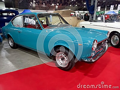 Old aqua blue 1972 Fiat 125 Sport coupe fastback berlinetta. Exhibit hall. Classic car show Editorial Stock Photo