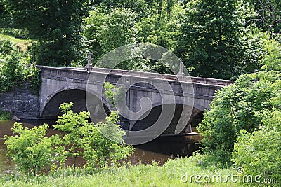Old arched span bridge countryside river Stock Photo