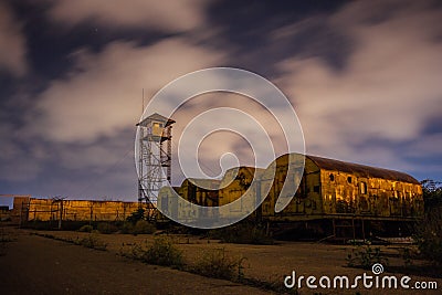 Old army watchtower in abandoned military base at night Stock Photo