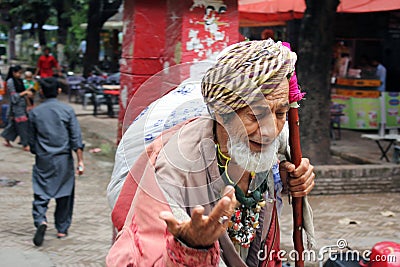 An old asian beggar faqeer malang poor homeless pakistani in asia is begging in streets Editorial Stock Photo