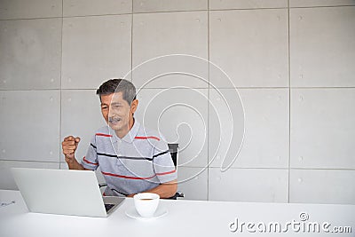 Old Asian man happy and smile with his success Stock Photo