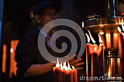 An old Asian man says his prayers Editorial Stock Photo