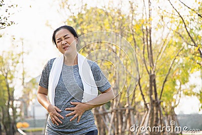 Old Asian people suffer from exercise pain.The old woman suffered from pain in the stomach Stock Photo
