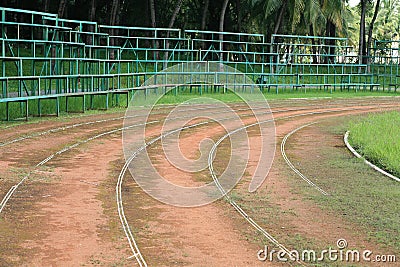 Old athletic curved track with bleacher Stock Photo