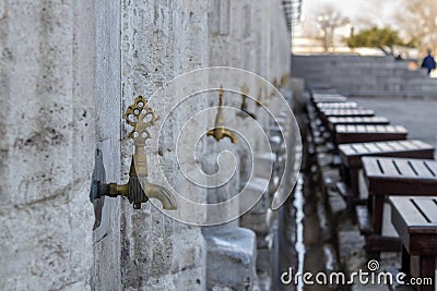 Old authentic iron faucet in the mosque for ablution Stock Photo