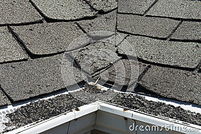 Old Bad and Curling Roof Shingles on a House or Home Stock Photo