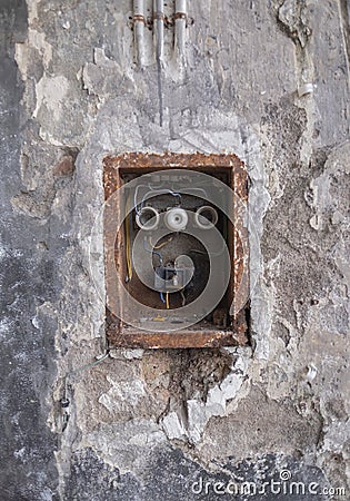 Old Bad Rusty Switch Box on the Weathered Wall Stock Photo