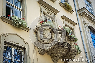 Old balcony with a lion head sculpture in Lviv Stock Photo