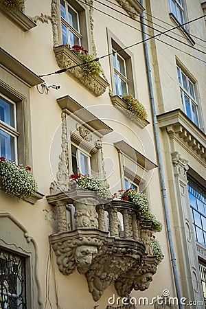 Old balcony with a lion head sculpture in Lviv Stock Photo
