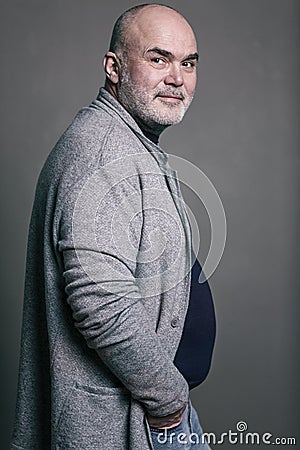 Old bald gray-haired smiling modern man in fashionable clothes Stock Photo