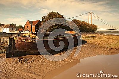 Old barge on mud bank. Stock Photo