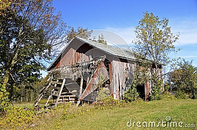 Old barn falling into ruins Stock Photo