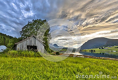 Old barn in Fjord landscape Norway Stock Photo