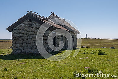 An old stone house stands on a green meadow. Oland, Sweden Stock Photo