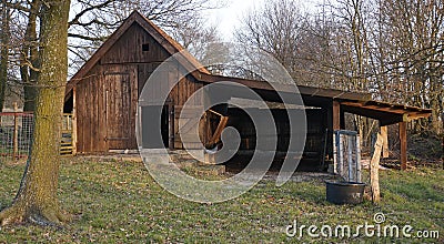 Old barn on the meadow used as a sheep shelter Stock Photo