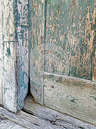 Closeup Detail of an Old Barn Door Bottom Painted Green, now Peeling and Weathered Wood Stock Photo