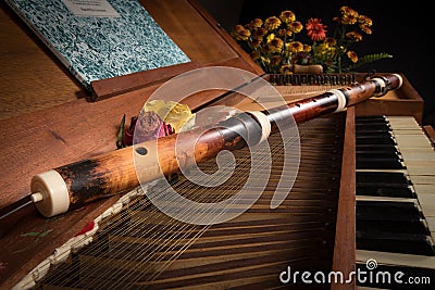 An old baroque clavichord and wooden traverse flute Stock Photo
