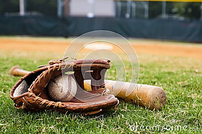 Old Baseball, Glove, and Bat on Field Stock Photo