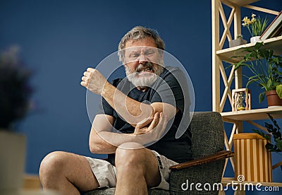 Old bearded man suffering from pain Stock Photo