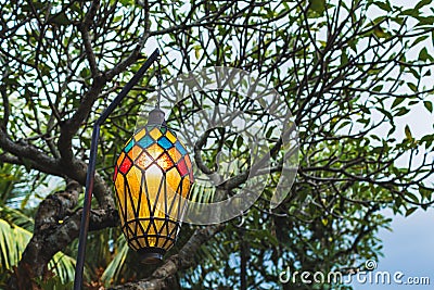 Old beautiful hanging lamp outside in cafe garden made from stained glass Stock Photo